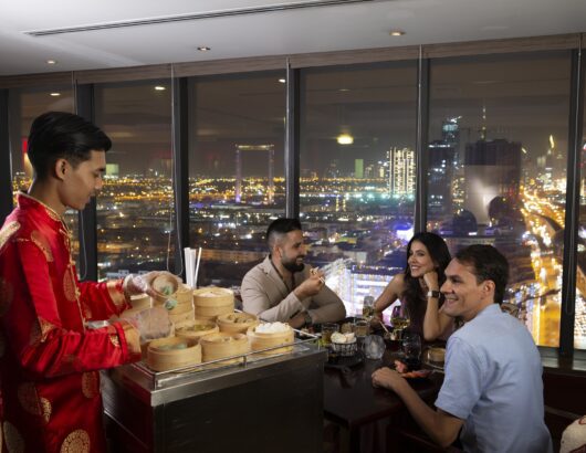Trio being served dumplings tableside at Kris with a View