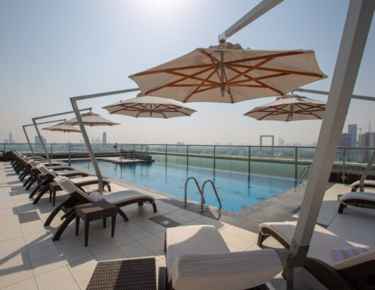 Park Regis Kris Kin Rooftop Pool with umbrellas and lounge chairs