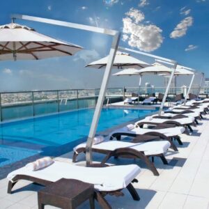 Park Regis Kris Kin rooftop swimming pool with hanging umbrellas